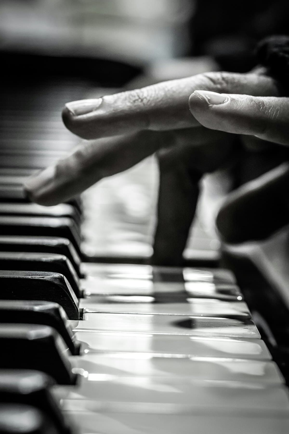 Hands poised over piano keys